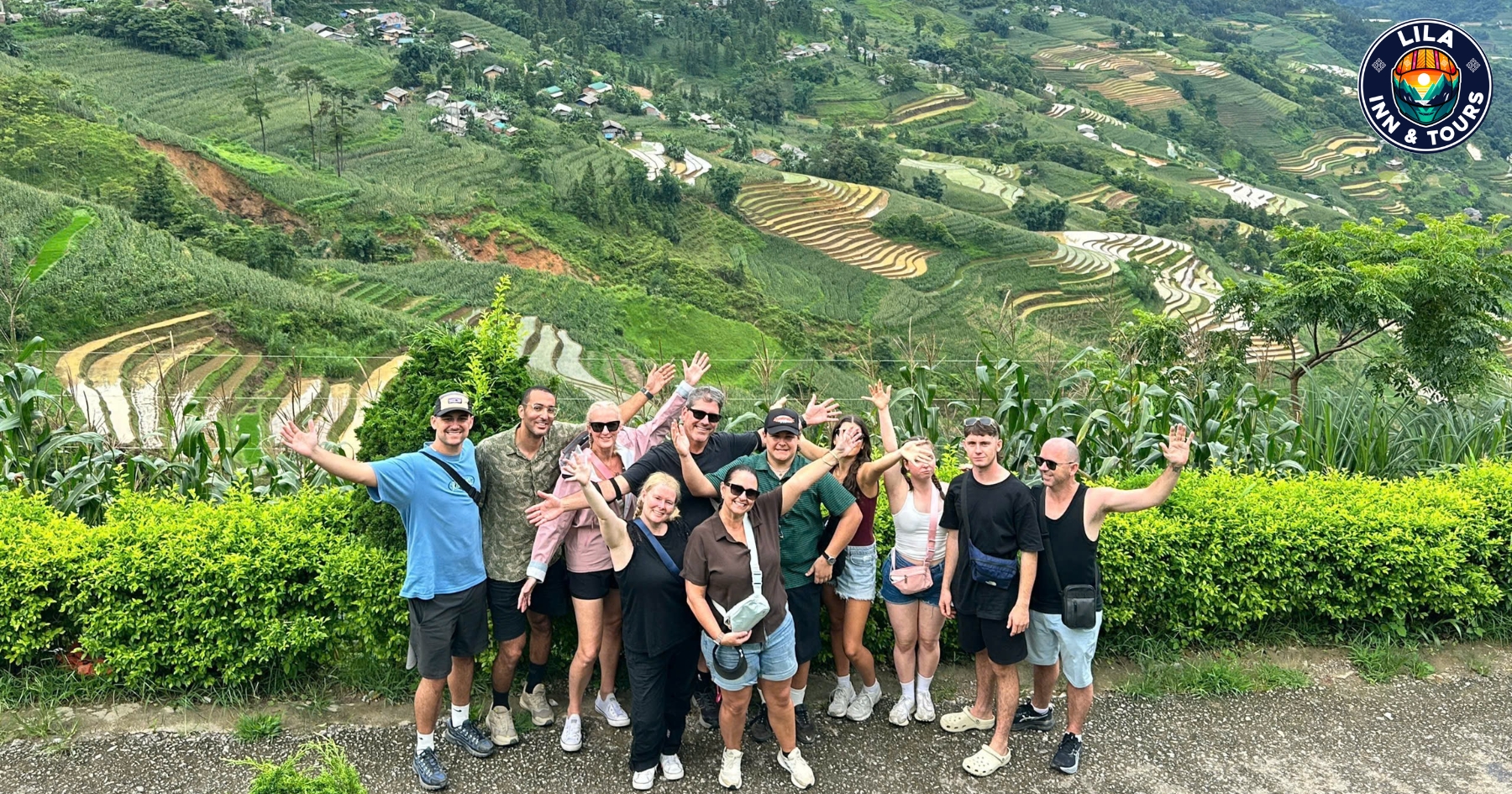 A group of tourists happily taking photos at the terraced rice fields